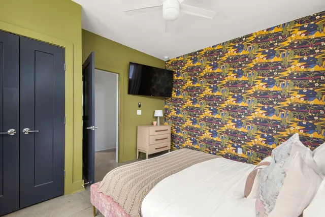 a bathroom with a granite countertop bathtub sink vanity mirror and toilet