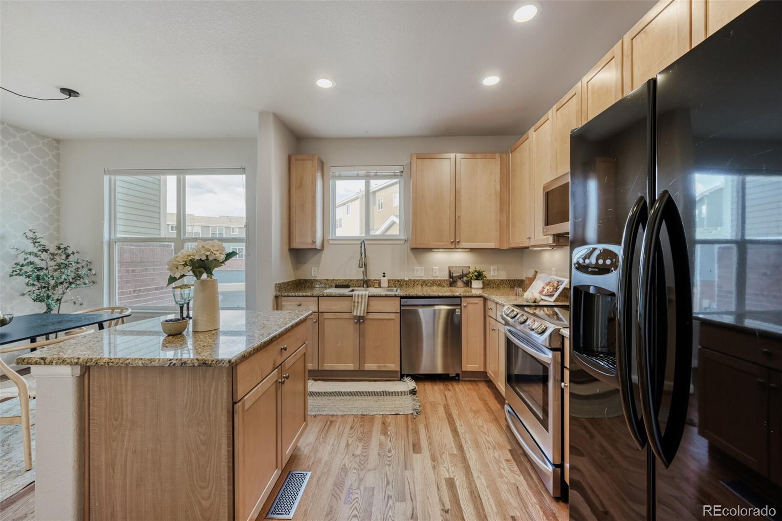 85 Uinta Way, Unit 106 Denver, CO 80230 - Photo 12 of 42 a kitchen with granite countertop a refrigerator stove and sink