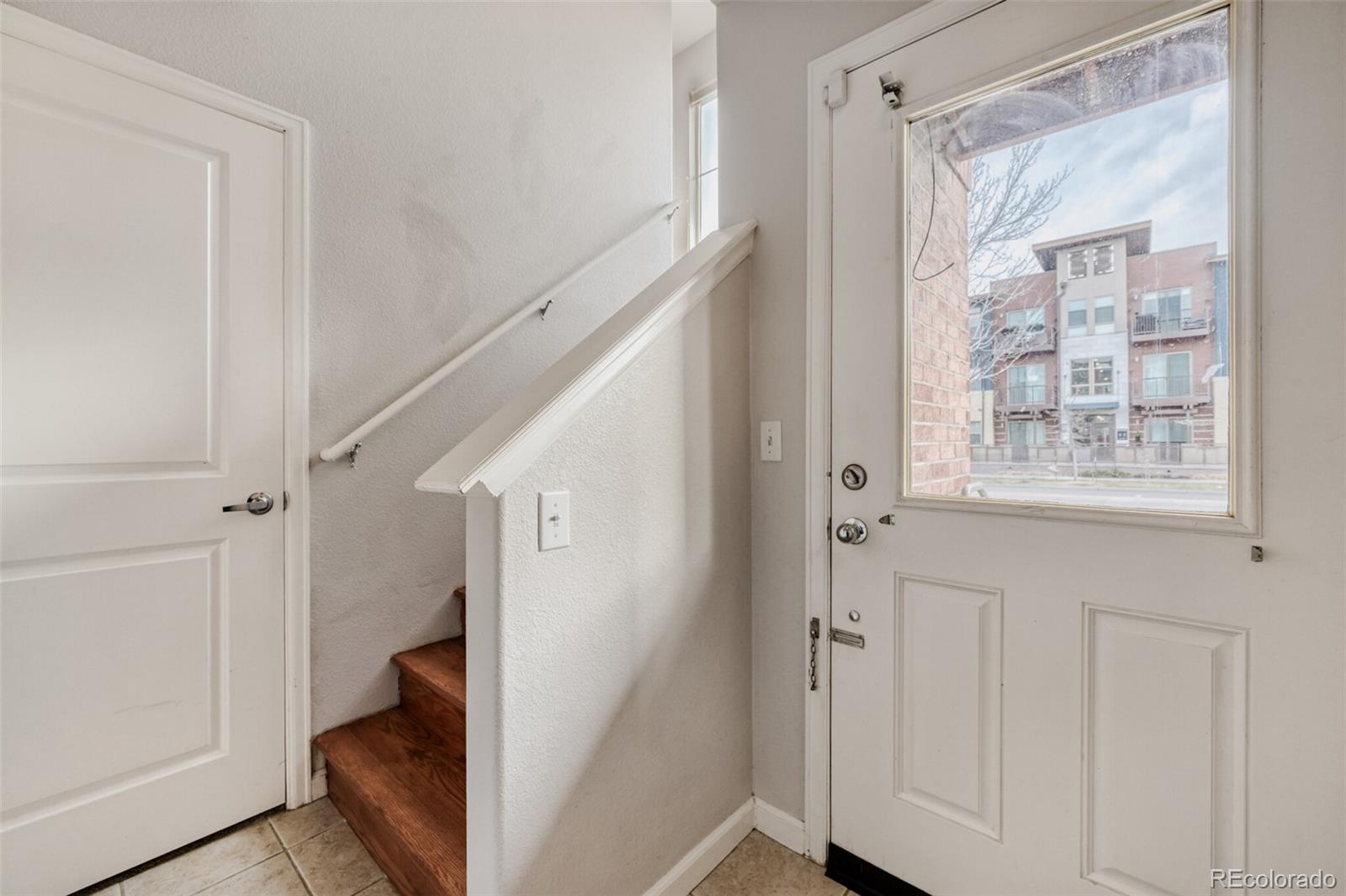 85 Uinta Way, Unit 106 Denver, CO 80230 - Photo 25 of 42 a view of a hallway with wooden floor and entryway