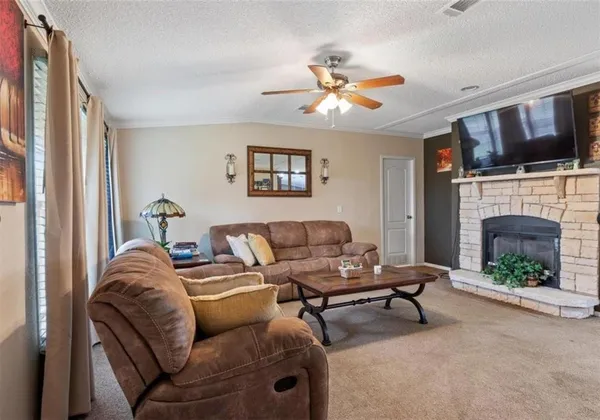 a living room with furniture fireplace and flat screen tv