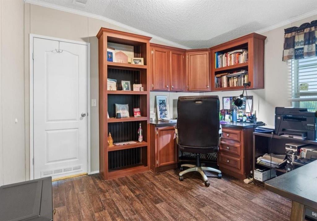 7141 County Road 1050 Celeste, TX 75423 - Photo 12 of 32 a view of a workspace with furniture and wooden floor