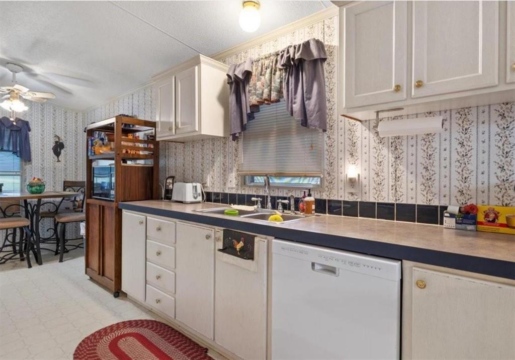 7141 County Road 1050 Celeste, TX 75423 - Photo 22 of 32 a kitchen with stainless steel appliances granite countertop a sink a stove and cabinets