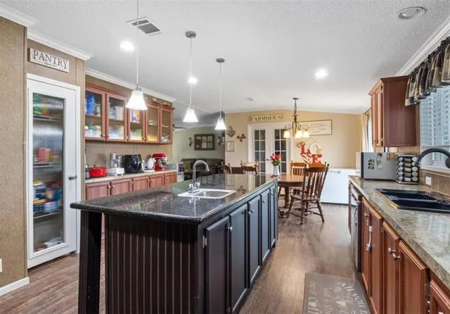 a kitchen with counter top space sink stove and refrigerator