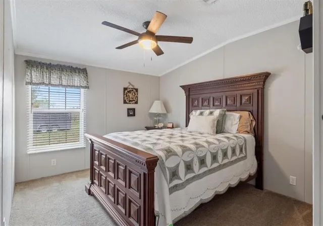 a bed sitting in a bedroom next to a window