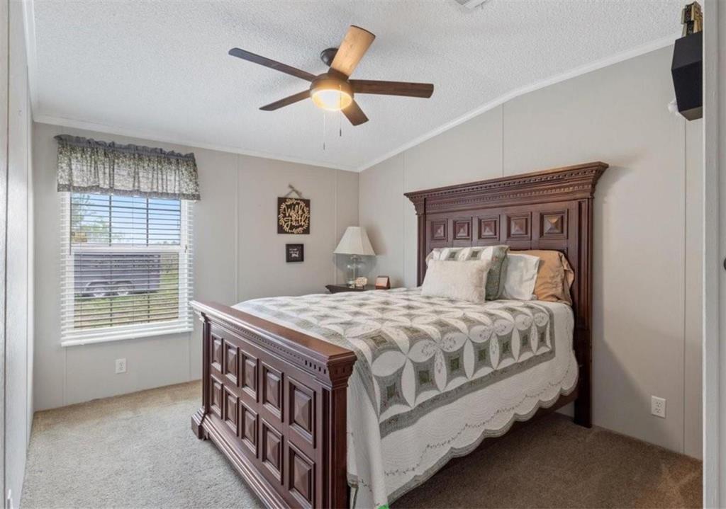 7141 County Road 1050 Celeste, TX 75423 - Photo 6 of 32 a bed sitting in a bedroom next to a window