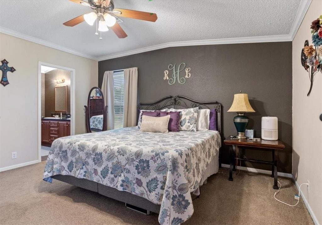 7141 County Road 1050 Celeste, TX 75423 - Photo 9 of 32 a bedroom with a bed and a chandelier