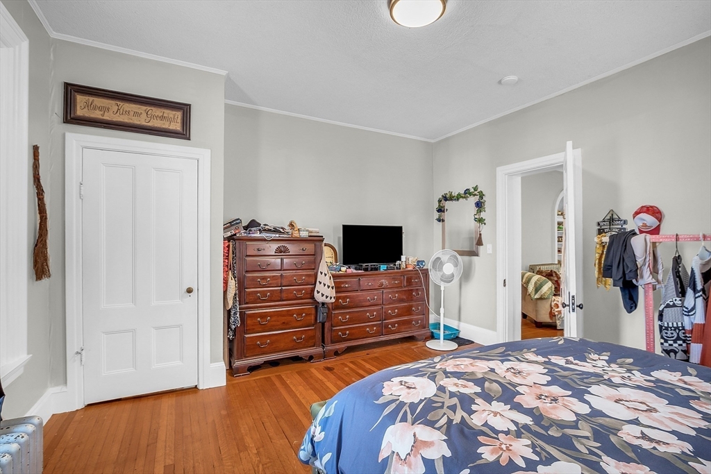 276 Pine Street Lowell, MA 01851 - Photo 16 of 42 a bedroom with a bed and a television