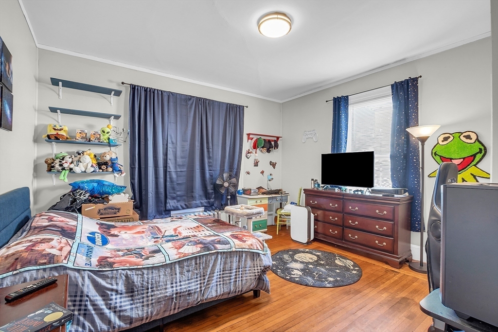276 Pine Street Lowell, MA 01851 - Photo 18 of 42 a bedroom with a bed and flat screen tv