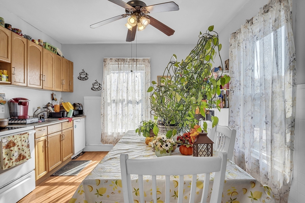 276 Pine Street Lowell, MA 01851 - Photo 27 of 42 a kitchen with stainless steel appliances a chandelier a sink and cabinets