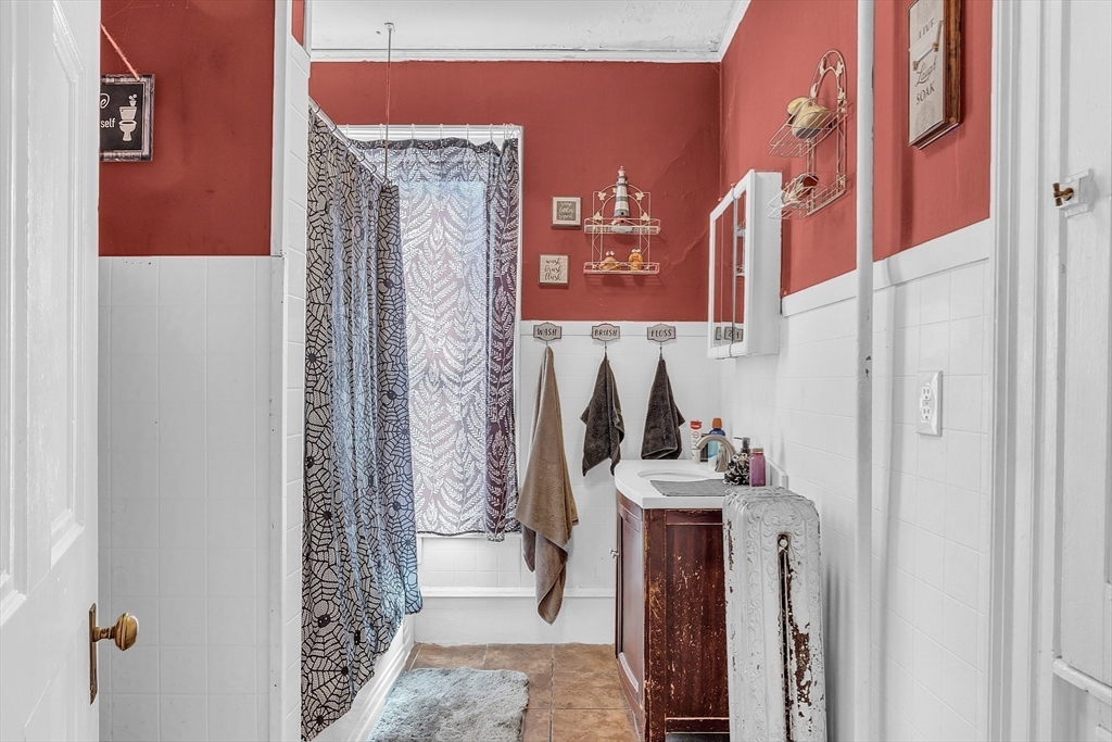 276 Pine Street Lowell, MA 01851 - Photo 28 of 42 a bathroom with a sink and a mirror