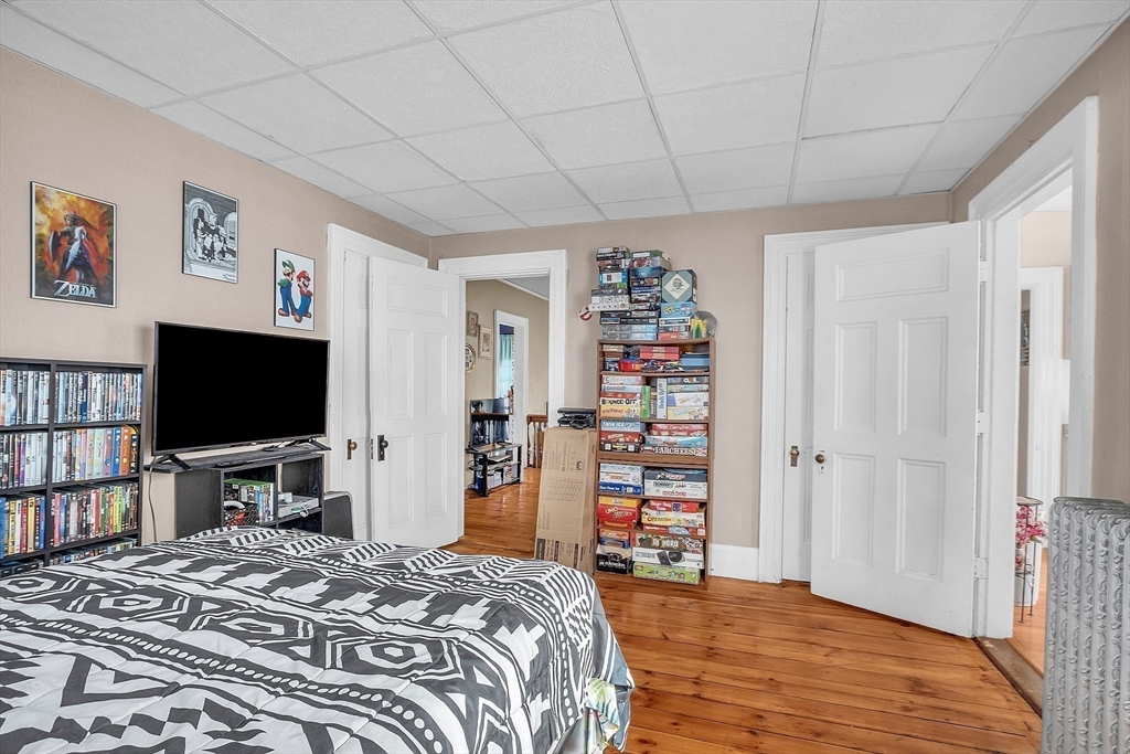 276 Pine Street Lowell, MA 01851 - Photo 33 of 42 a bedroom with a bed and a flat screen tv