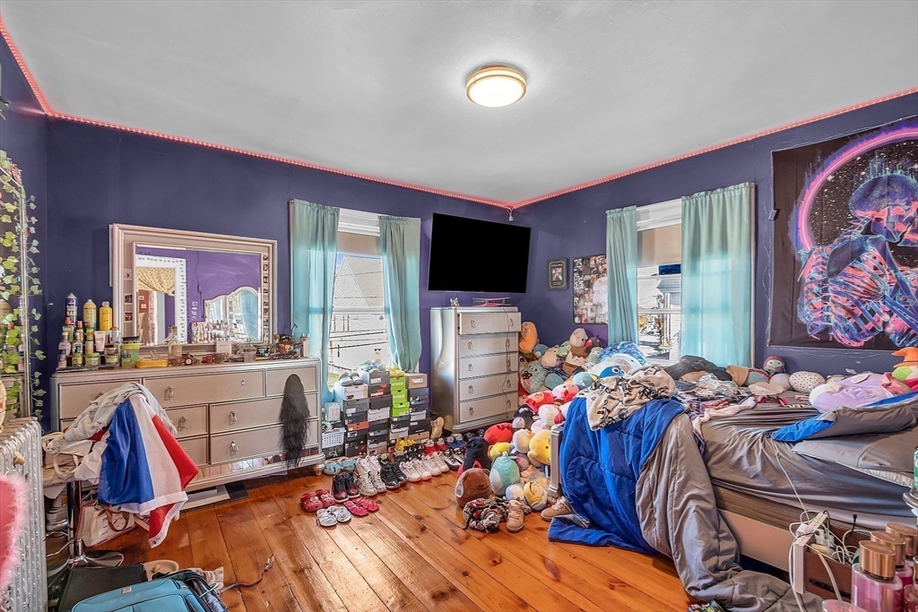 276 Pine Street Lowell, MA 01851 - Photo 34 of 42 a bed room with a bed and a large mirror