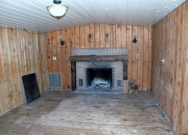 a view of an empty room with a fireplace