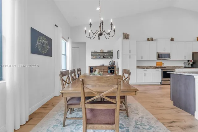 a bedroom with a bed next to a window and a flat screen tv
