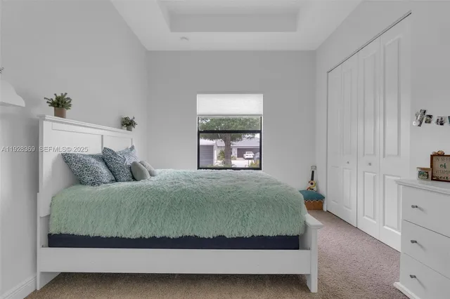 a spacious bedroom with a bed and a window