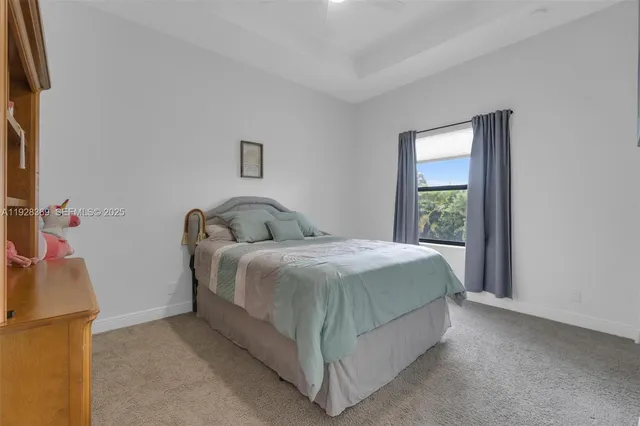 a bathroom with a granite countertop toilet sink and mirror