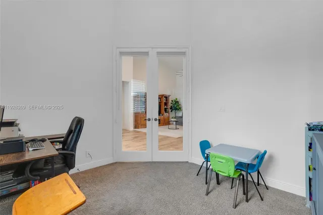 a bedroom with furniture and a large window