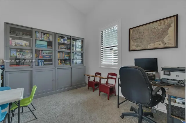 a living room with couch and a floor to ceiling window