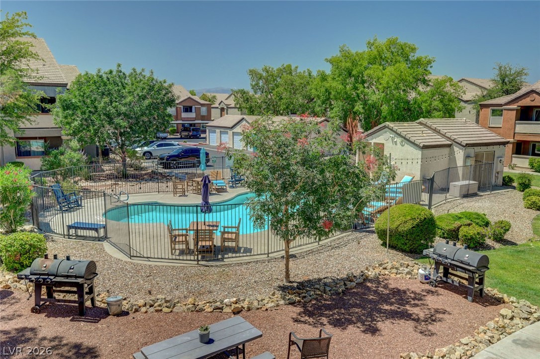 555 East Silverado Ranch Boulevard, Unit 2124 Las Vegas, NV 89183 - Photo 1 of 47 An inviting outdoor community area features a sparkling pool and dedicated grilling stations.