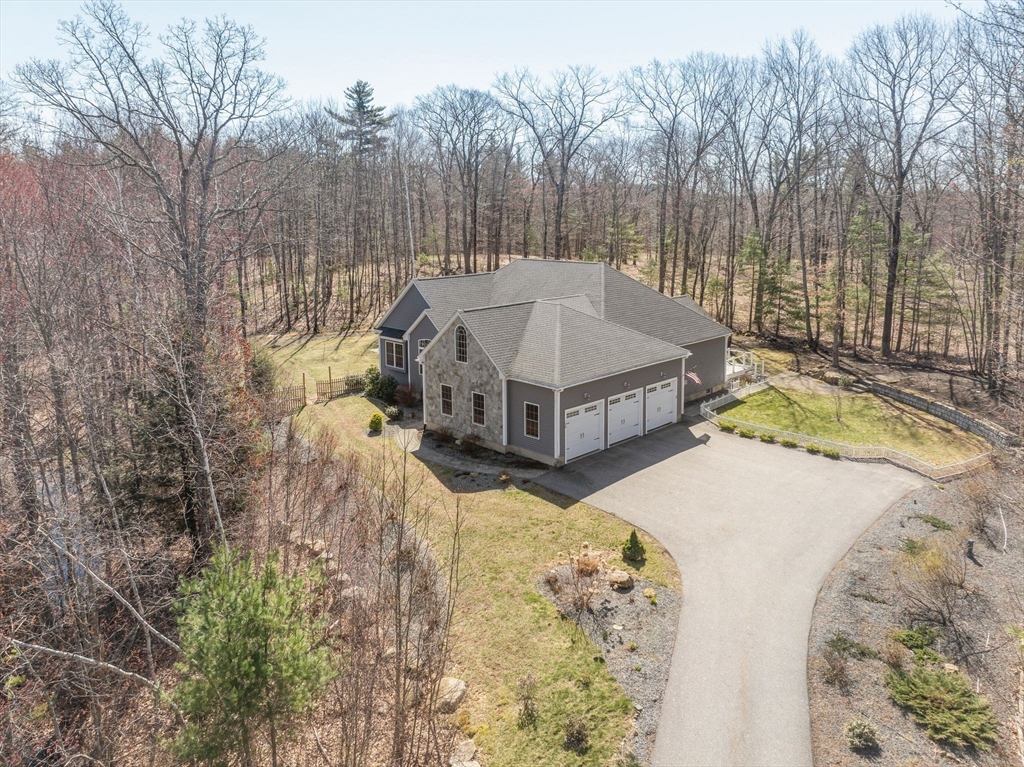 a view of a house with a yard and sitting area