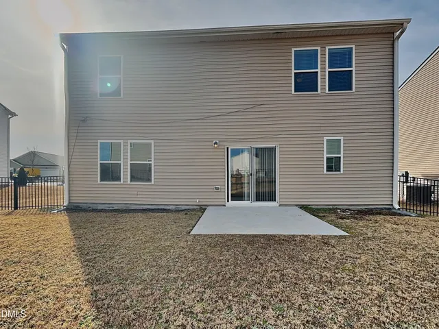 a view of a house with backyard and porch