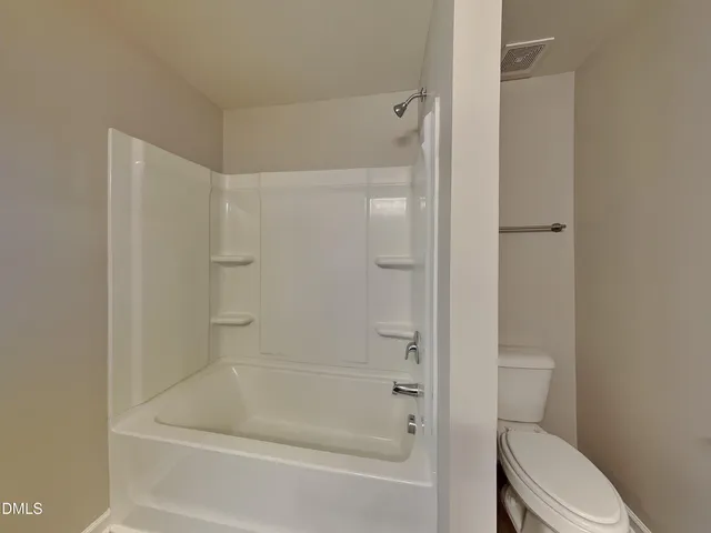 a bathroom with a bathtub and a toilet