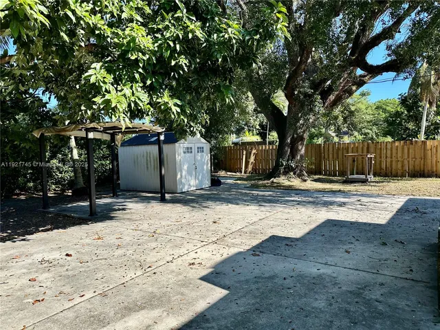 a street view with large trees