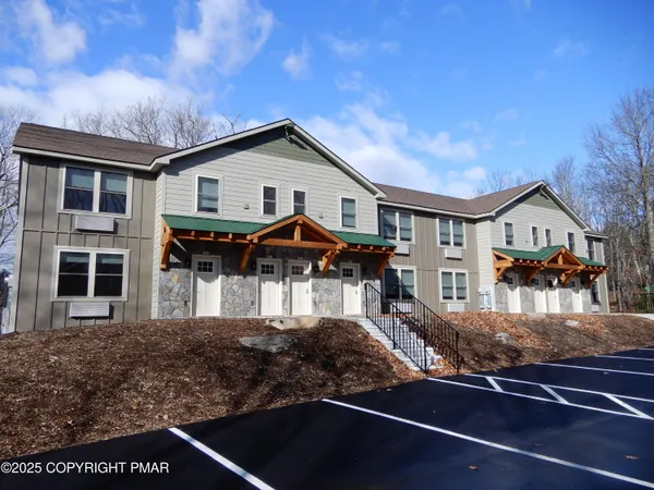 a front view of a house with balcony and porch