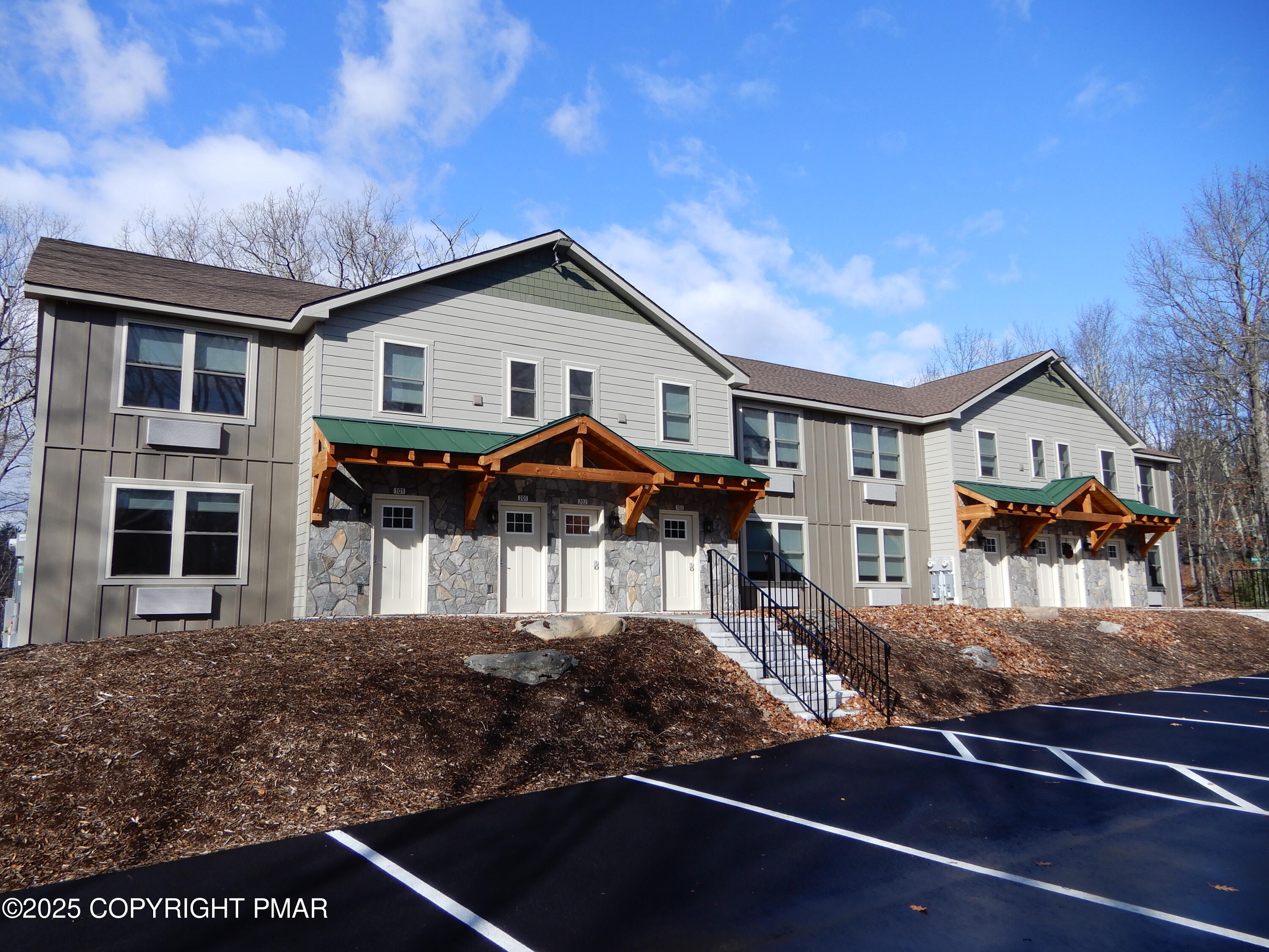 101 Brook Village Scotrun, PA 18355 - Photo 1 of 18 a front view of a house with balcony and porch