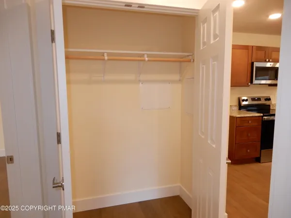a bathroom with a granite countertop toilet sink and mirror