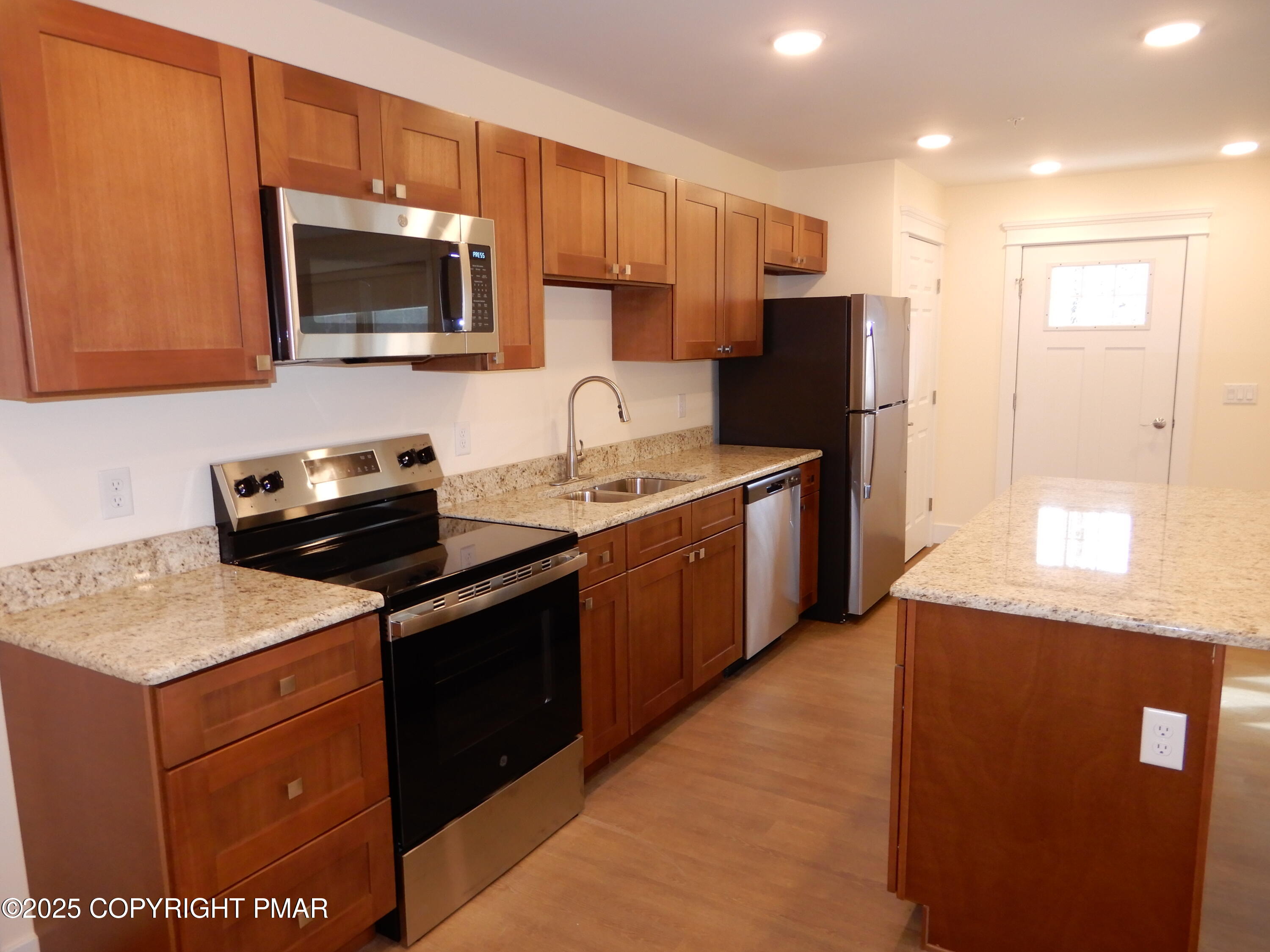 101 Brook Village Scotrun, PA 18355 - Photo 8 of 18 a kitchen with stainless steel appliances granite countertop a sink stove and refrigerator