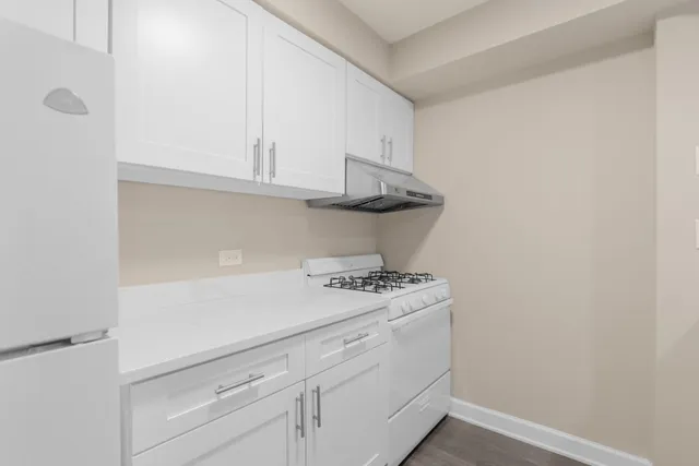 a kitchen with a stove and cabinets