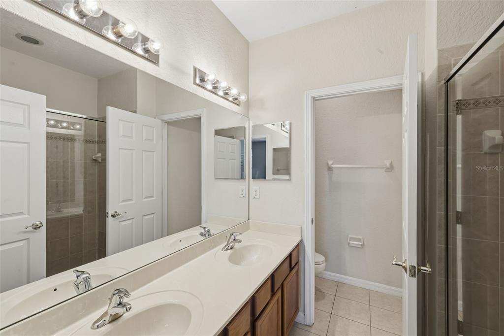 3914 Silverlake Way Wesley Chapel, FL 33544 - Photo 18 of 38 a bathroom with a sink double vanity and a mirror