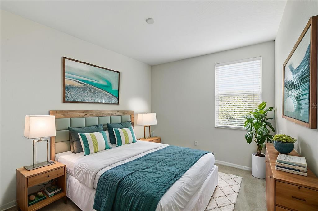 3914 Silverlake Way Wesley Chapel, FL 33544 - Photo 22 of 38 a bedroom with a bed and a potted plant