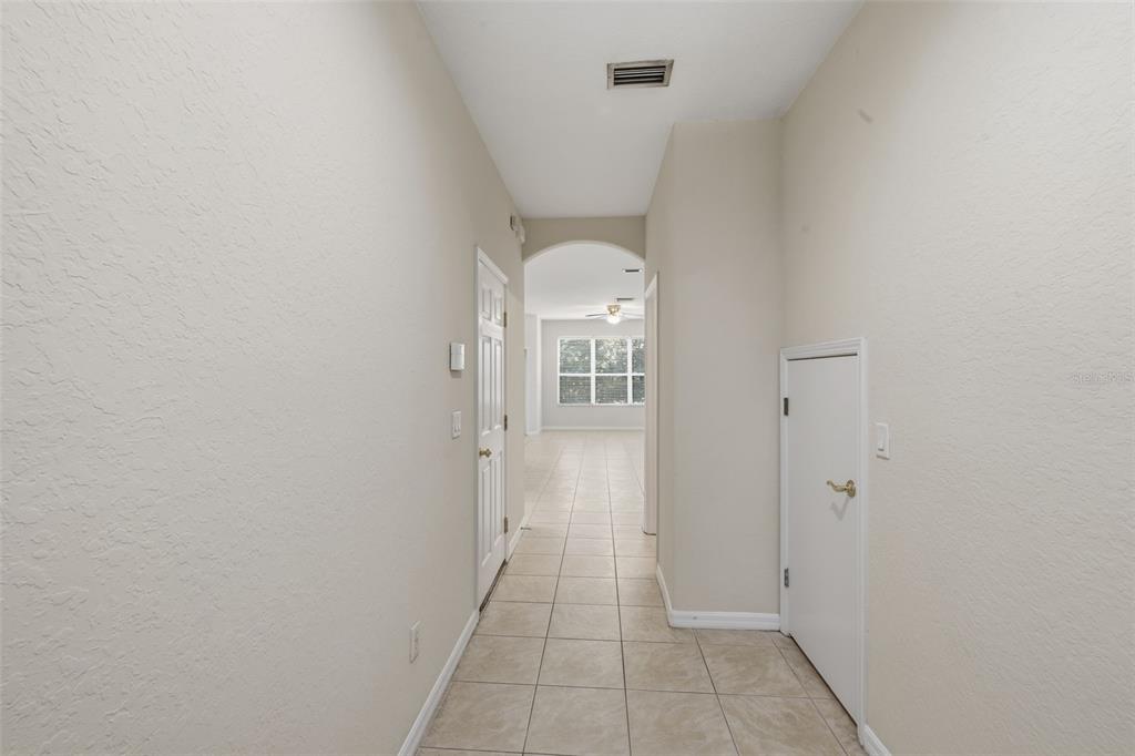 3914 Silverlake Way Wesley Chapel, FL 33544 - Photo 3 of 38 a view of a hallway with a white walls