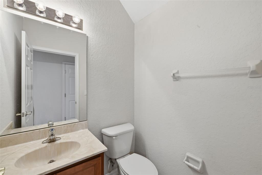 3914 Silverlake Way Wesley Chapel, FL 33544 - Photo 9 of 38 a bathroom with a sink mirror and a toilet