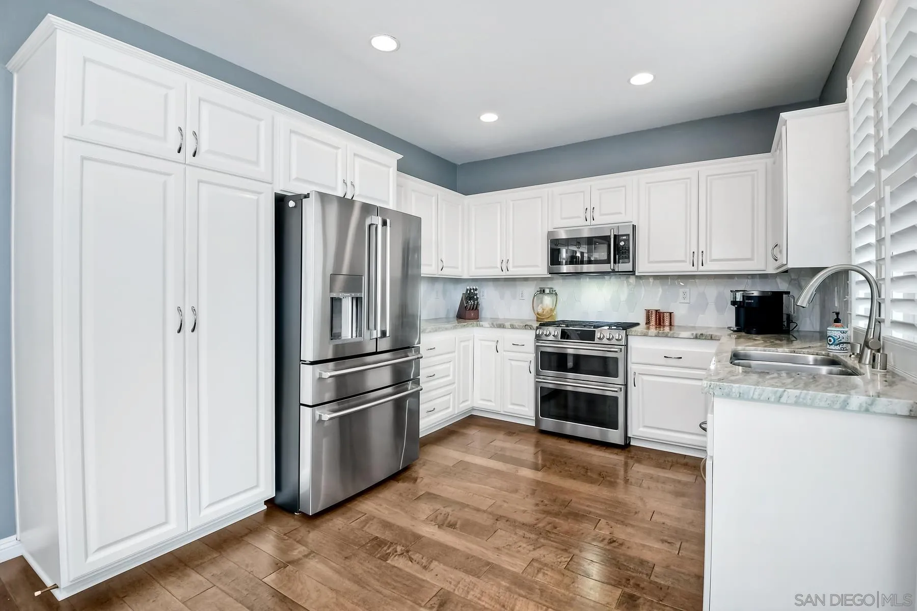 1145 Monterey Place Encinitas, CA 92024 - Photo 15 of 34 a kitchen with cabinets stainless steel appliances and a window
