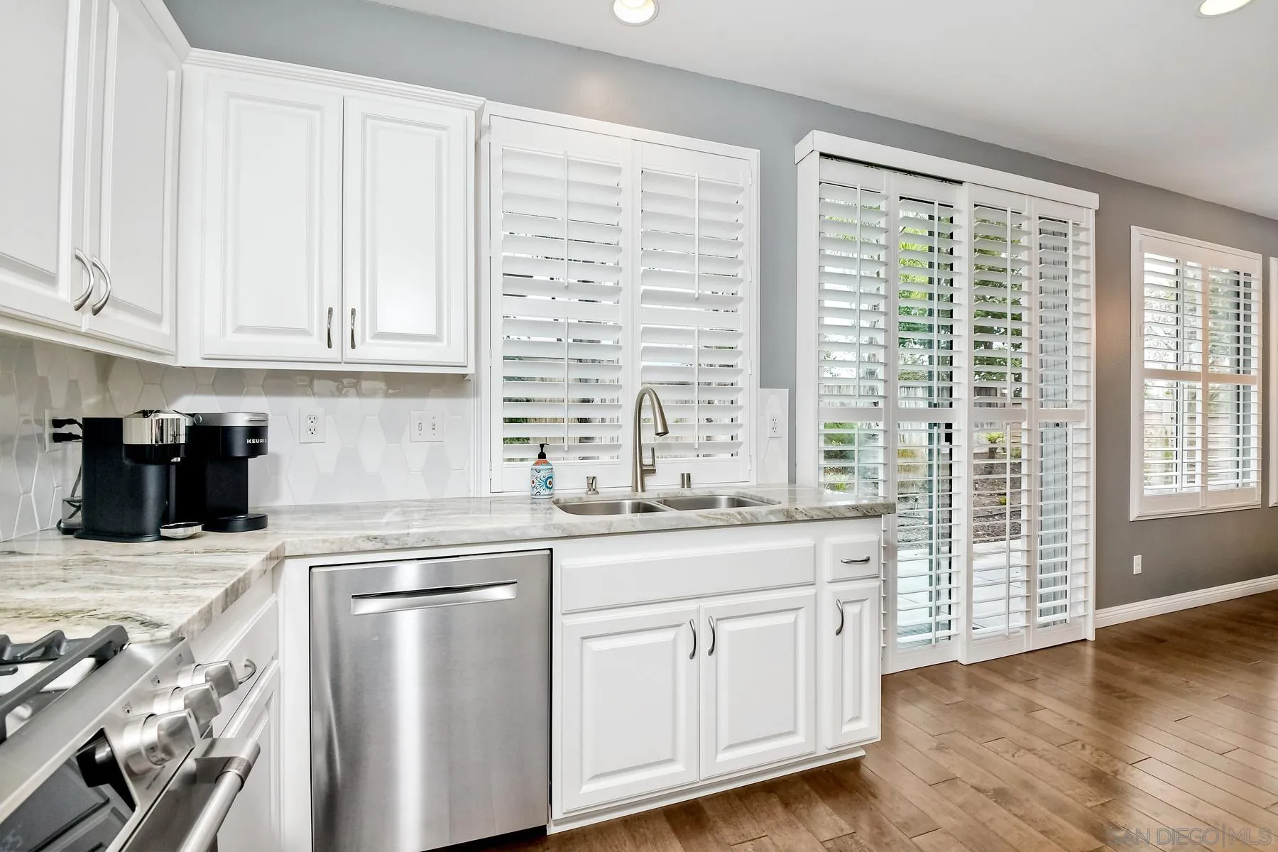 1145 Monterey Place Encinitas, CA 92024 - Photo 18 of 34 a kitchen with granite countertop a sink and white cabinets