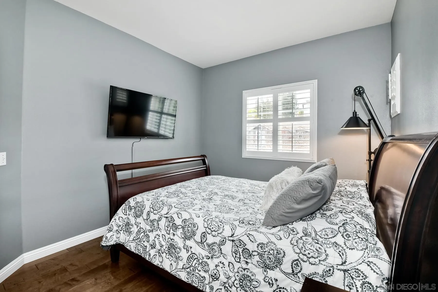 1145 Monterey Place Encinitas, CA 92024 - Photo 24 of 34 a bedroom with a bed a flat screen tv and windows