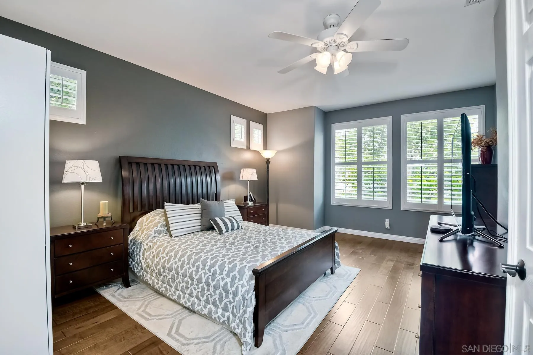 1145 Monterey Place Encinitas, CA 92024 - Photo 25 of 34 a bedroom with a large bed and a flat tv screen on dresser