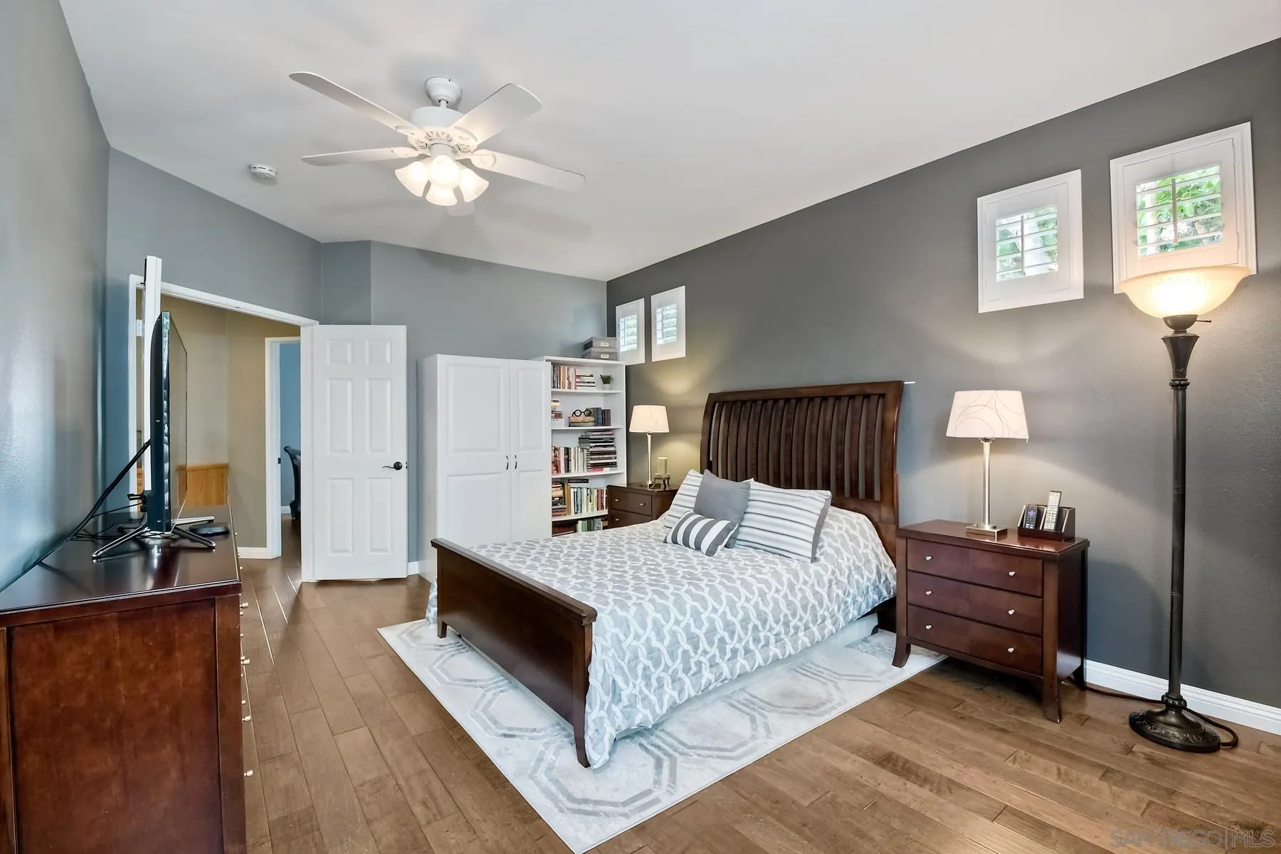 1145 Monterey Place Encinitas, CA 92024 - Photo 27 of 34 a bedroom with a large bed a lamp and a flat screen tv