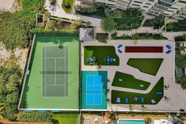 a view of a swimming pool with outdoor seating and plants