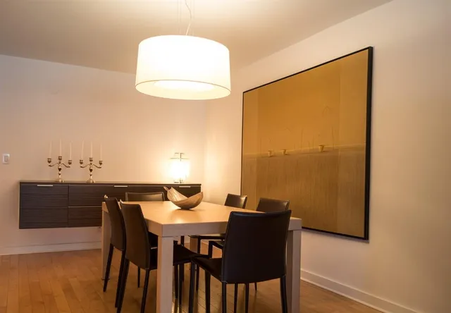 a bedroom with a bed a mirror and lamp on desk