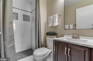 14727 McKnew Road Burtonsville, MD 20866 - Photo 12 of 20 a bathroom with a granite countertop sink toilet and shower