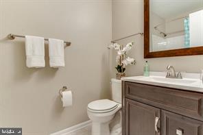 14727 McKnew Road Burtonsville, MD 20866 - Photo 14 of 20 a bathroom with a sink vanity mirror and toilet
