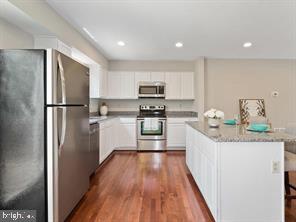 14727 McKnew Road Burtonsville, MD 20866 - Photo 2 of 20 a kitchen with granite countertop a refrigerator and a stove top oven