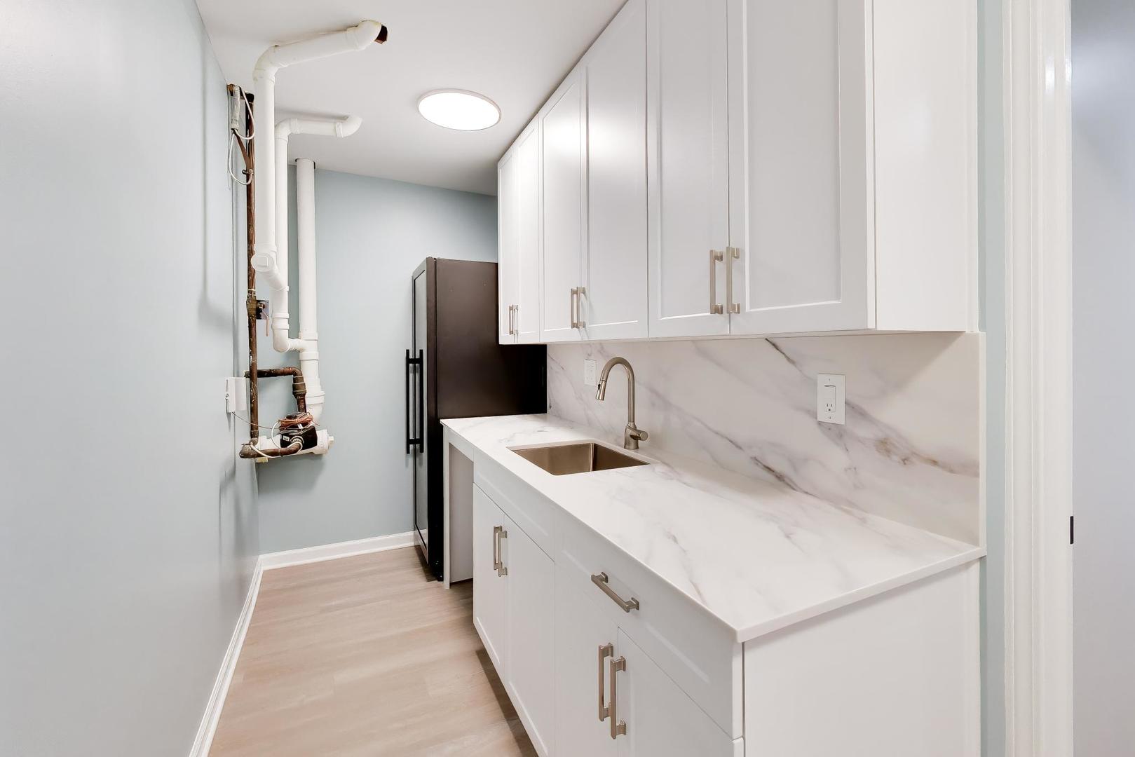 232 West Scott Street Chicago, IL 60610 - Photo 29 of 39 a kitchen with a sink cabinets and utility