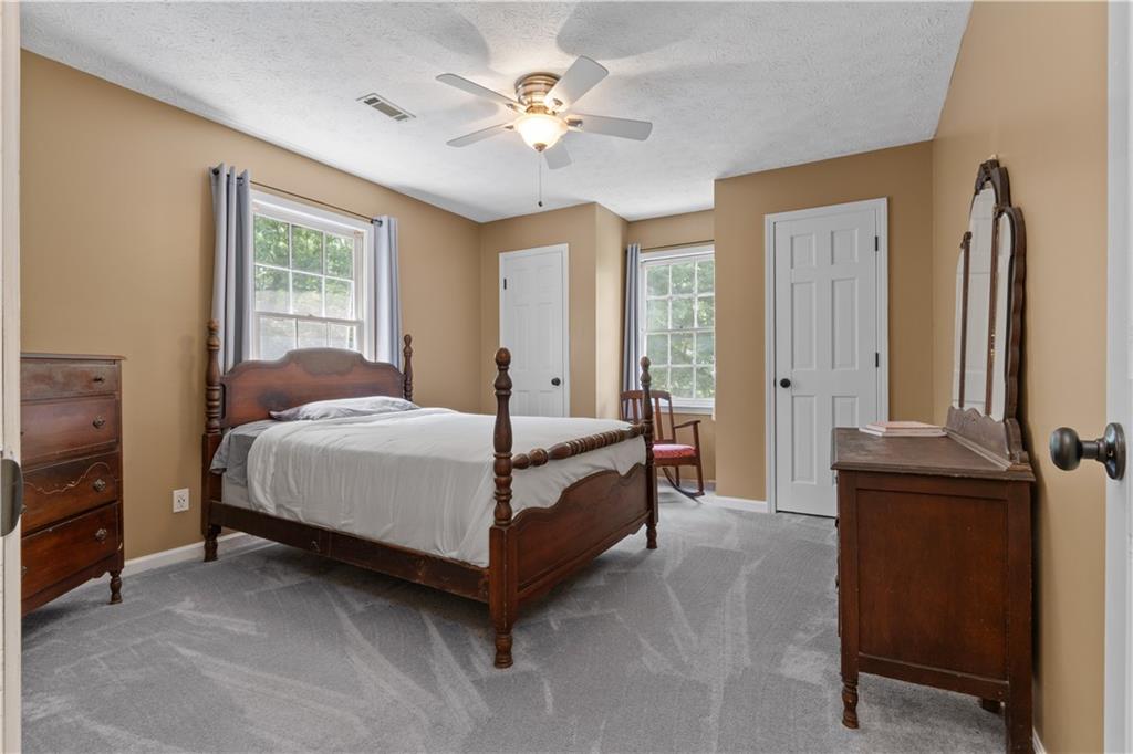 112 Brannon Road Buchanan, GA 30113 - Photo 21 of 40 a bed room with a bed and a chandelier