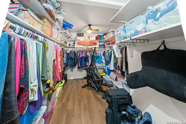 a view of walk in closet with clothes