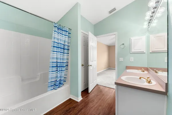 a bathroom with a bathtub sink and mirror